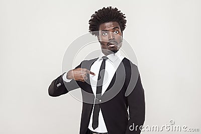 Amazement aloof afro man looking at camera. Studio shot, gray ba Stock Photo