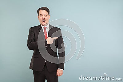 Amazement businessman pointing finger to copy space Stock Photo