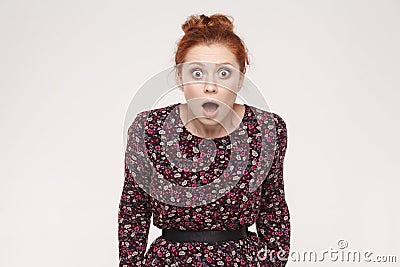 Amazement redhead young woman is shocked. open mouth and big eye Stock Photo