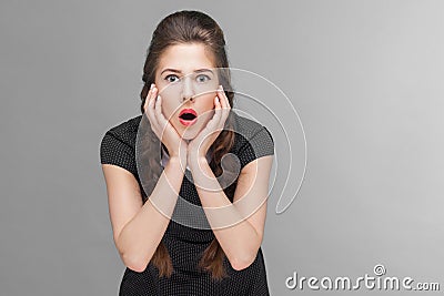 Amazement woman looking at camera with touching cheeks Stock Photo