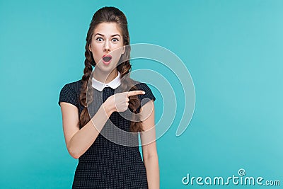 Amazement, wondered woman pointing finger right, at copy space. Stock Photo