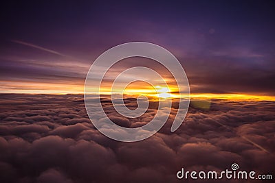 Amazing and beautiful sunset above the clouds with dramatic clouds Stock Photo