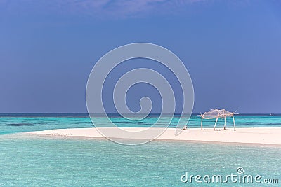 Amazing blue water in a desert island, blue sky day, wood hut Stock Photo