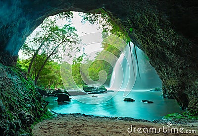 Amazing cave in deep forest with beautiful waterfalls background Stock Photo