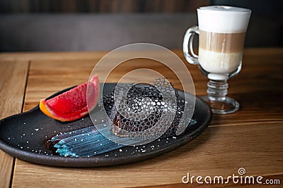 Amazing chocolate dessert with ice cream and three-layer latte. Fancy dessert, chocolate brownie. Sweet bakery and Stock Photo