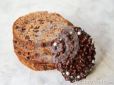 Amazing Chocolate Easter Cake with chocolate drops and dry cherries on gray wooden background. Round slices of cake. Easter Stock Photo