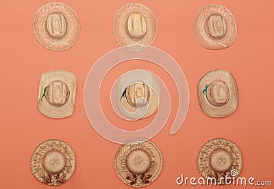 amazing collection of various fashionable vintage stylish straw hats on orange background Stock Photo