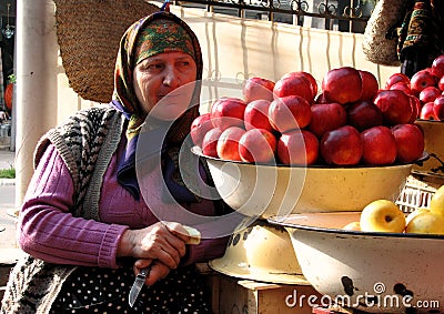 Amazing Display of Apples and an Old Woman Stock Photo