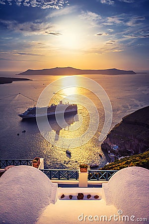 Amazing evening view of Fira, caldera, volcano of Santorini, Greece with cruise ships at sunset. Stock Photo