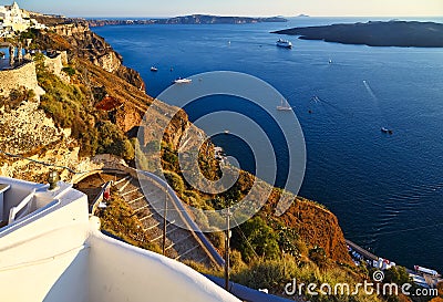 Amazing evening view of Fira, caldera, volcano of Santorini with steps to the sea, Greece with cruise ship at sunset. Stock Photo