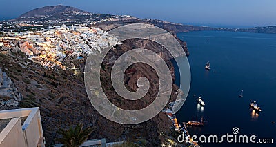 Amazing evening view of Fira with cruise ships Stock Photo