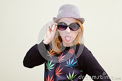 Amazing hipster girl in sunglasses showing off her Stock Photo