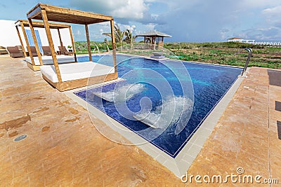 Amazing inviting beautiful view of resort spa and swimming pool with aqua massage beds Editorial Stock Photo