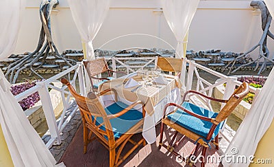 amazing inviting closeup view of dinner table inside the outdoor gazebo on sunny day Stock Photo