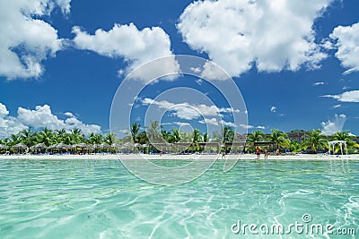 Amazing inviting view of Cuban, Cayo Coco beach from the tranquil turquoise ocean side, with people in background Stock Photo