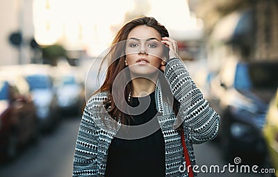 Amazing joyful pretty girl with long brunette hair. posing outdoor. Close up fashion street stile portrait Stock Photo