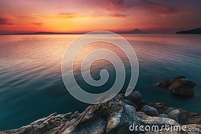 Amazing landscape of sunrise at sea. Colorful morning view of dramatic sky. Seascape. Greece. Mediterranean Sea. Stock Photo