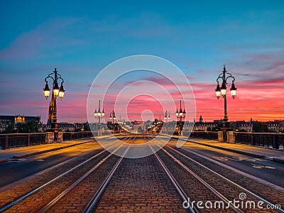 Amazing low angle view of the Bordeaux Stone Bridge and amazing sunset sky over the Bordeaux city, France. Stock Photo