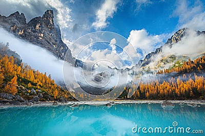 Amazing misty autumn scenery with lake Sorapis, Dolomites, Italy Stock Photo