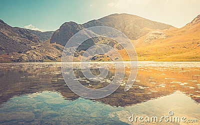 Amazing mountain lake between Bolkar Mountain and Taurus Mountain. Panoramic view of black lake. Nigde, Turkey. Volcanic crater. Stock Photo