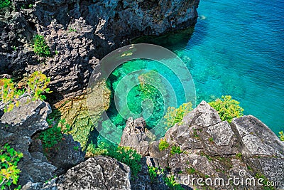 Amazing natural rocks, cliffs view above tranquil azure clear water at beautiful, inviting Bruce Peninsula, Ontario Stock Photo