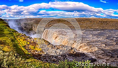 Amazing nature landscape, stunning Dettifoss waterfall with rocky canyon and blue cloudy sky Iceland. Scenic panoramic aerial view Stock Photo