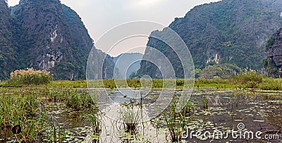 Amazing panorama view of the rice fields, limestone rocks and mountaintop Pagoda from Hang Mua Temple viewpoint. Stock Photo