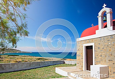 Amazing pictorial view of an old stone church beside blue sea, Milatos, Crete. Stock Photo