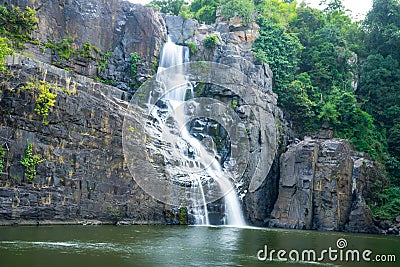 Amazing Pongour waterfall in Vietnam, Da Lat with the Buddha on the top. Stock Photo