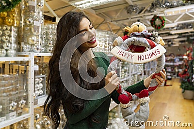 Amazing pretty long hair woman smiling and holding happy holidays wreath Stock Photo