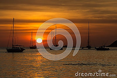 Amazing red sunset on the Nai Harn beach in Phuket Stock Photo