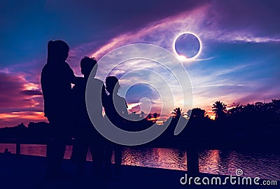 Natural phenomenon. Three person looking at total solar eclipse. Stock Photo