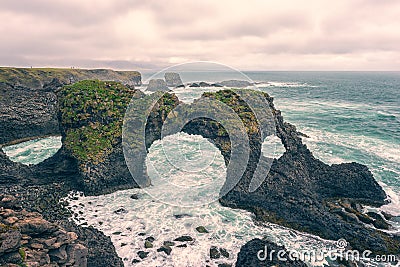 Amazing seascape, Gatklettur basalt rock arch at the volcanic cliff, Atlantic coast, Arnarstapi, Iceland Stock Photo