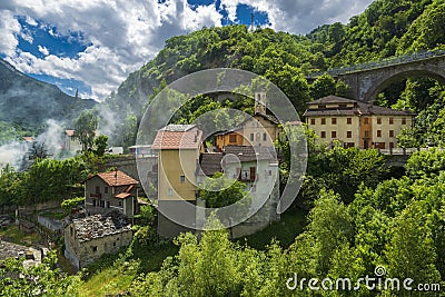 Amazing small alpine town in the narrow mountain valley Stock Photo