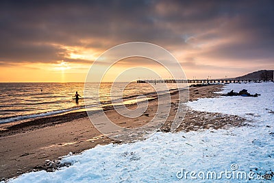 Amazing snowy beach in Gdynia Orlowo at sunrise, Baltic Sea. Poland Stock Photo