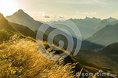 Beautiful sunrise and layered mountain silhouettes in early morning. Lechtal and Allgau Alps, Bavaria and Austria. Stock Photo