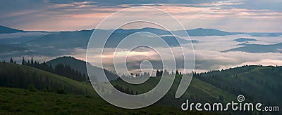 Amazing sunrise in the mountains. Great view of the foggy valley with bright sun rays in Carpathians. Stock Photo