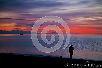 Amazing sunrise with a silhouette of fisherman Stock Photo