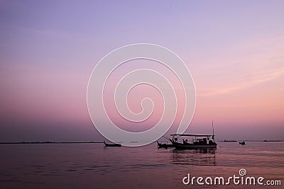 Amazing sunrise with silhouette image fishing boat view as a foreground.Nature composition:Ideal use for background Stock Photo