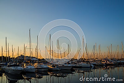 Amazing sunset, boats in the harbor, yachts in a bay of lake at sunset light. Editorial Stock Photo