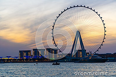 Amazing sunset colors over the sea view to the Ain Dubai, giant Ferris at Bluewaters Island close to JBR beach. Stock Photo