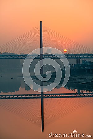 Amazing sunset over a bridge and river Stock Photo