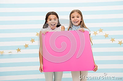 Amazing surprising news. Girl hold announcement banner. Girls kids holding paper banner for announcement. Children happy Stock Photo