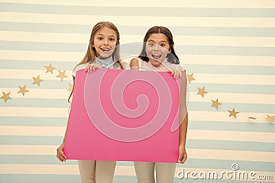 Amazing surprising news. Girl hold announcement banner. Girls kids holding paper banner for announcement. Children happy Stock Photo