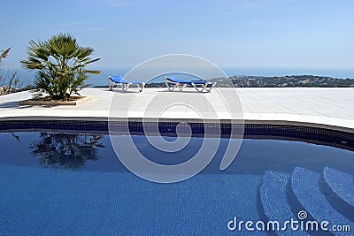 Amazing swimming pool in spanish villa with incredible views to the town and sea below. Stock Photo