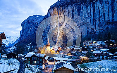 amazing touristic alpine village at night in winter with famous church and Staubbach waterfall Lauterbrunnen Switzerland Europe Editorial Stock Photo