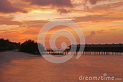 Amazing Twilight Phenomenon with Overwater Bungalow at a resort island, Maldives Stock Photo