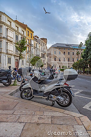 Amazing view of the city parking for scooters on Paseo Del Parque in Malaga. Close up photo on lots of parked assorted scooters. Editorial Stock Photo