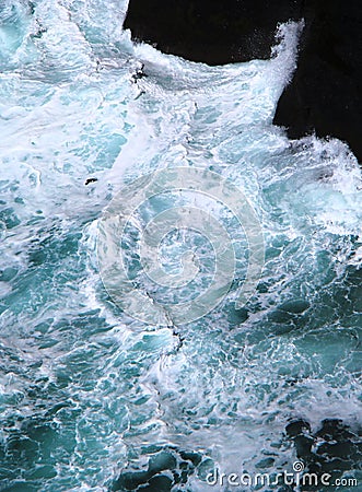 Magnificent colors of water while powerful waves crashing into rocks Stock Photo