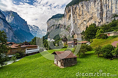 Amazing view of famous Lauterbrunnen town in Swiss Alps valley with Staubbach waterfalls in the background, Switzerland Stock Photo